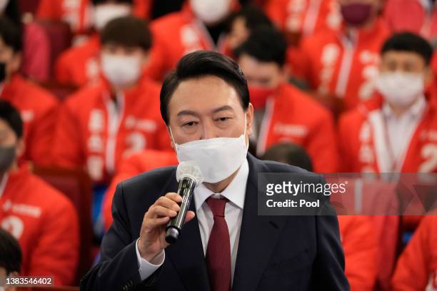 South Korean President-elect Yoon Suk-yeol of the main opposition People Power Party celebrates with party members and lawmakers at the National...