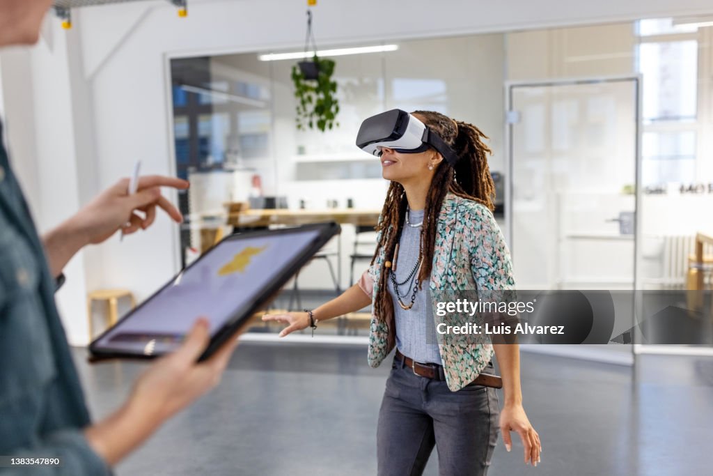 Startup business colleagues testing out metaverse in office