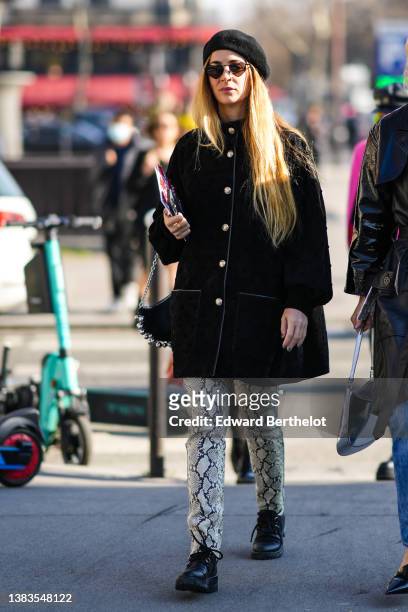Guest wears a black felt / wool beret, a black suede coat from Chanel, a black shiny leather with embroidered silver pearls handbag, a beige / black...