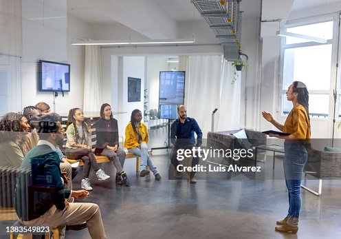 Young asian businesswoman speaking to her coworkers in meeting Young asian businesswoman speaking to her coworkers in meeting