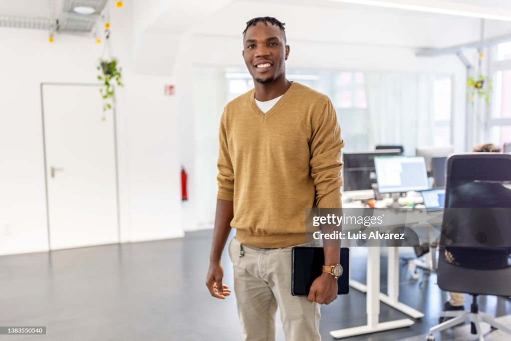 Portrait of African businessman standing in office