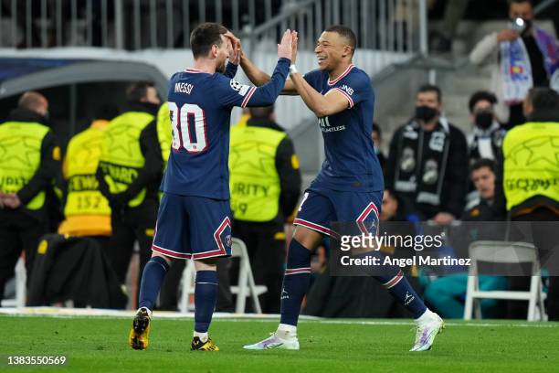 Kylian Mbappe of Paris Saint-Germain celebrates their sides first goal with team mate Lionel Messi during the UEFA Champions League Round Of Sixteen...