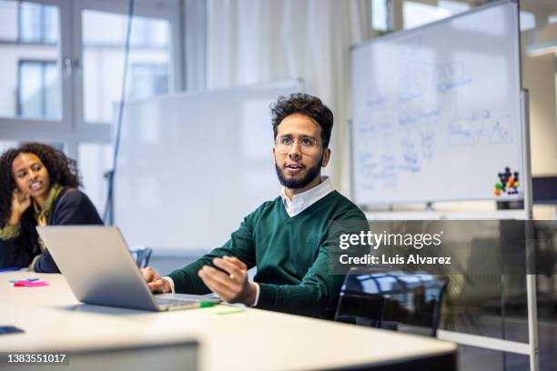 business people meeting in office conference room - confident businessman sitting with colleagues in office stock pictures, royalty-free photos & images