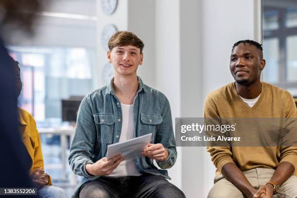 multi-ethnic business people sitting in circle and discussing new strategies - open discussion stock pictures, royalty-free photos & images