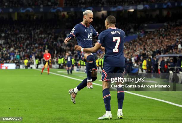 Kylian Mbappe of Paris Saint-Germain celebrates with teammate Neymar after scoring their team's first goal during the UEFA Champions League Round Of...