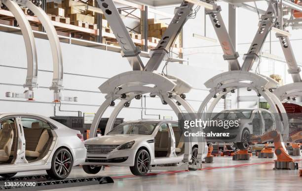 cars on the production line in a factory - auto industrie stockfoto's en -beelden