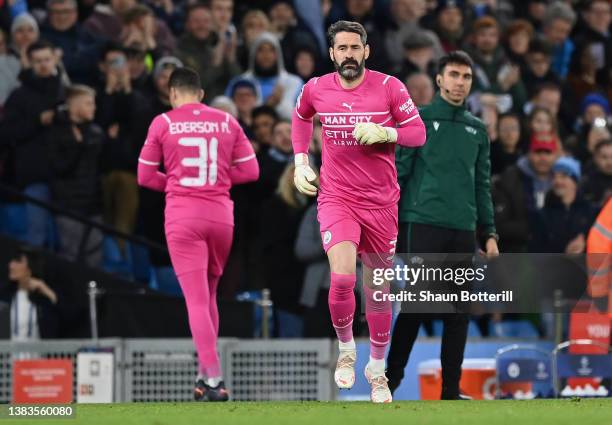 Scott Carson of Manchester City makes their way onto the pitch to replace team mate Ederson during the UEFA Champions League Round Of Sixteen Leg Two...