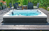 Large hot tub embedded in the backyard terrace