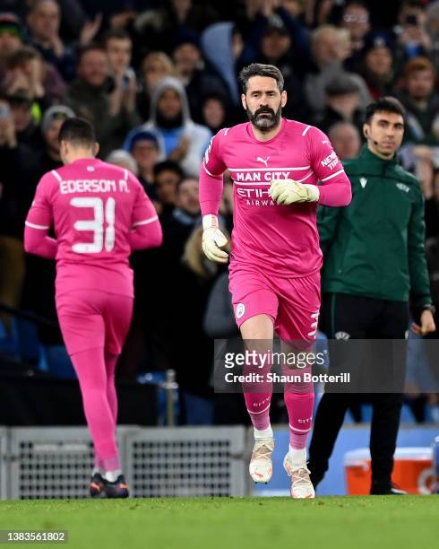 Scott Carson of Manchester City makes their way onto the pitch to replace team mate Ederson during the UEFA Champions League Round Of Sixteen Leg Two...