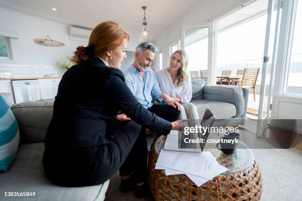 happy mature couple meeting investments and financial advisor at home. - inheritance consulting stockfoto's en -beelden