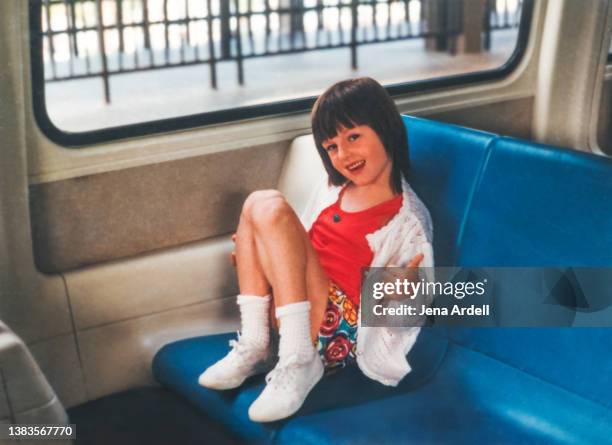 happy 1990s child wearing vintage 90s fashion style giving thumbs up train travel traveling - geste de la main photos et images de collection