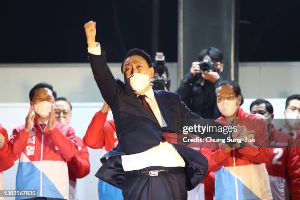 South Korean President-elect Yoon Suk-yeol of the main opposition People Power Party celebrates with supporters at the party's headquarters on March...