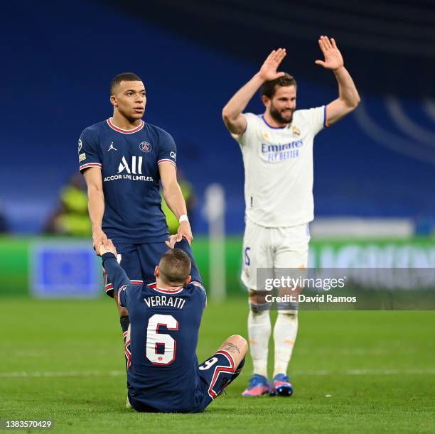 Kylian Mbappe of Paris Saint-Germain interacts with teammate Marco Verratti as Nacho Fernandez of Real Madrid celebrates following the UEFA Champions...