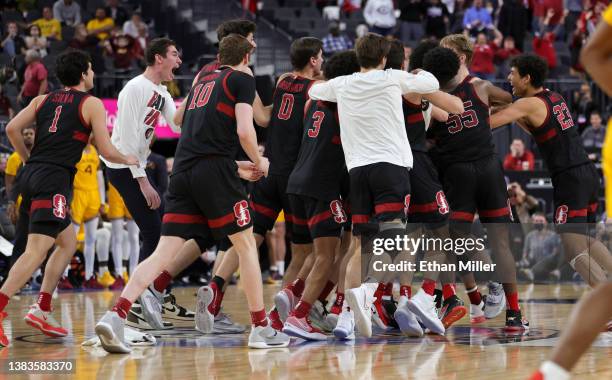 The Stanford Cardinal celebrate on the court after James Keefe hit a game-winning shot against the Arizona State Sun Devils as time expired in their...