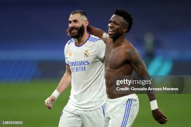 Karim Benzema and Vinicius Junior of Real Madrid celebrate following their side's victory in the UEFA Champions League Round Of Sixteen Leg Two match...