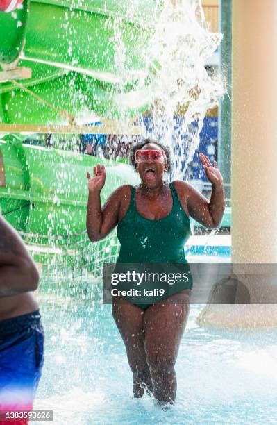 african-american woman getting wet at water park - water slide stock pictures, royalty-free photos & images