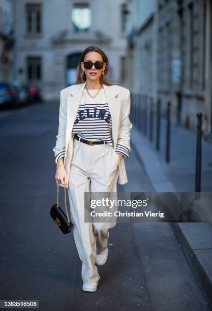 Alexandra Lapp is seen wearing PERNILLE x MANGO blazer and trousers in crème, CELINE striped jumper in crème, CELINE Triomphe bag in black, CELINE...