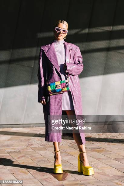 Maxine Wylde wears a lavender Rotate by Birger Christensen coat, Louis Vuitton bag and Versace shoes at Melbourne Fashion Festival 2022 on March 09,...