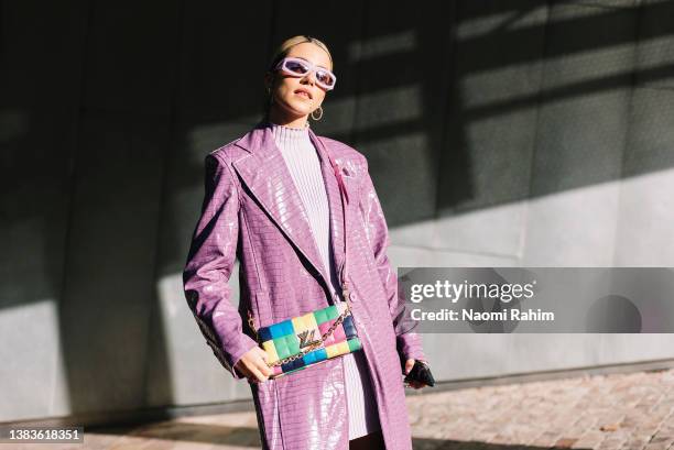 Maxine Wylde wears a lavender Rotate by Birger Christensen coat, Louis Vuitton bag and Versace shoes at Melbourne Fashion Festival 2022 on March 09,...