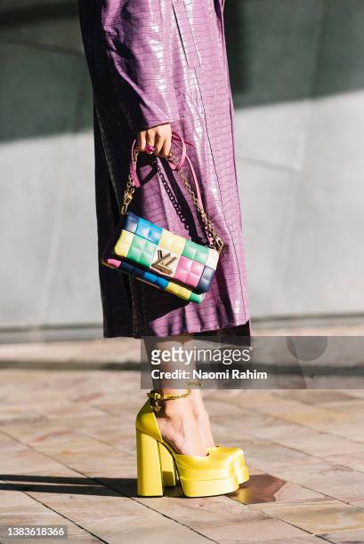 Maxine Wylde wears a lavender Rotate by Birger Christensen coat, Louis Vuitton bag and Versace shoes at Melbourne Fashion Festival 2022 on March 09,...