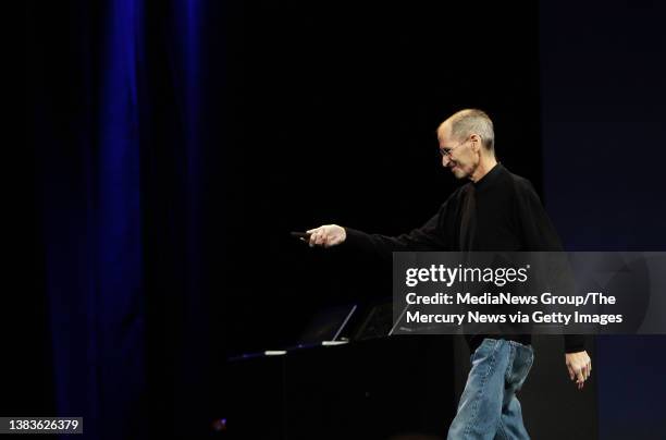 Apple CEO Steve Jobs triggers his presentation as he takes the stage to greet the crowd during his keynote speech at Apple's World Wide Developers...