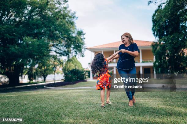 grandmother and granddaughter dancing outdoors - child dancing stock pictures, royalty-free photos & images