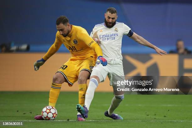 Karim Benzema of Real Madrid CF competes for the ball with goalkeeper Gianluigi Donnarumma of Paris Saint-Germain during the UEFA Champions League...