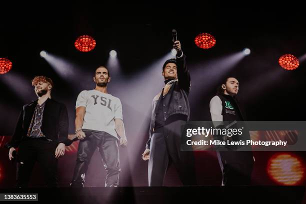 Jay McGuiness, Max George, Siva Kaneswaran and Nathan Sykes of The Wanted perform on stage at Motorpoint Arena Cardiff on March 09, 2022 in Cardiff,...