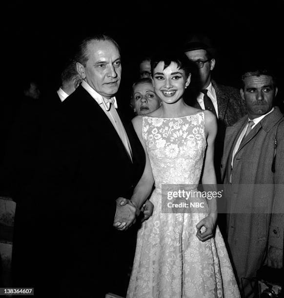Pictured: Actor, Frederick March, and actress, Audrey Hepburn wearing a Givenchy gown, during the 26th Annual Academy Awards in New York City, on...