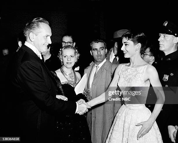 New York Ceremony -- Air Date -- Pictured: Fredric March congratulates Best Actress winner Audrey Hepburn for "Roman Holiday" during the 26th Annual...