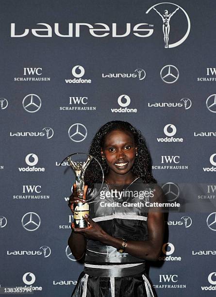 Vivian Cheruiyot poses with her Laureus World Sportswoman of the Year trophy in the press room at the 2012 Laureus World Sports Awards at Queen...