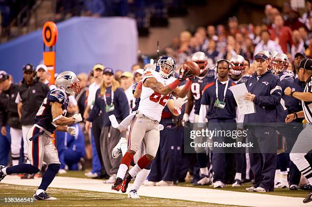 Super Bowl XLVI: New York Giants Mario Manningham in action, making catch vs New England Patriots Sterling Moore at Lucas Oil Stadium. Sequence....