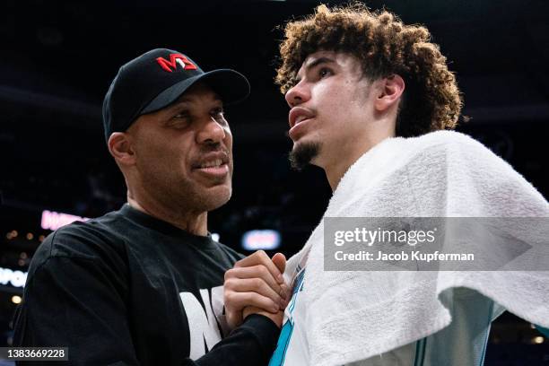 LaVar Ball talks with LaMelo Ball of the Charlotte Hornets after their game against the Boston Celtics at Spectrum Center on March 09, 2022 in...