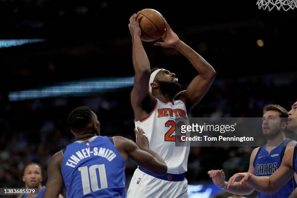 Mitchell Robinson of the New York Knicks dunks the ball against Dorian Finney-Smith of the Dallas Mavericks in the first half at American Airlines...