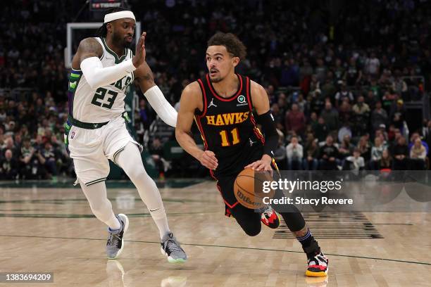 Trae Young of the Atlanta Hawks drives around Wesley Matthews of the Milwaukee Bucks during the second half of a game at Fiserv Forum on March 09,...