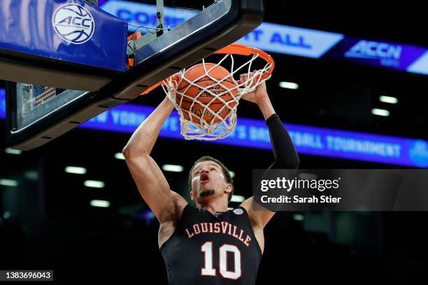 Samuell Williamson of the Louisville Cardinals dunks during the first half against the Virginia Cavaliers in the 2022 Men's ACC Basketball Tournament...