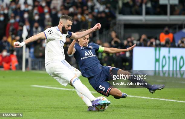 Karim Benzema of Real Madrid scores his second goal despite Marquinhos of PSG during the UEFA Champions League Round Of Sixteen Leg Two match between...
