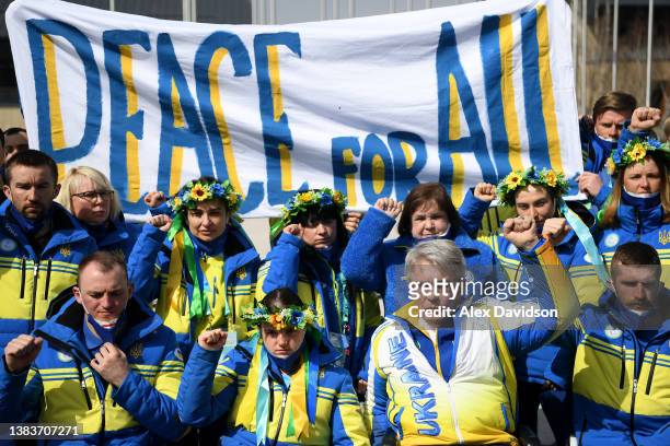 President of Ukraine’s Paralympic Committee Valerii Sushkevych and Members of Team Ukraine hold a banner up reading 'Peace for All' in the Athletes...