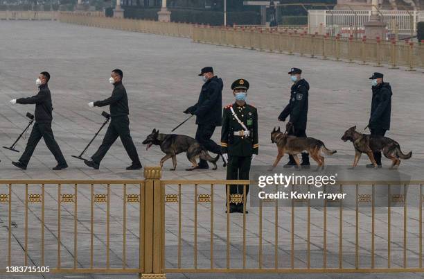 The Chinese police canine and explosives unit do a security sweep in Tiananmen Square before the closing session of the Chinese People's Political...