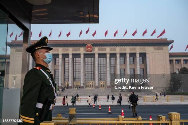 Police officer stands guard before the closing session of the Chinese People's Political Consultative Conference at the Great Hall of the People on...