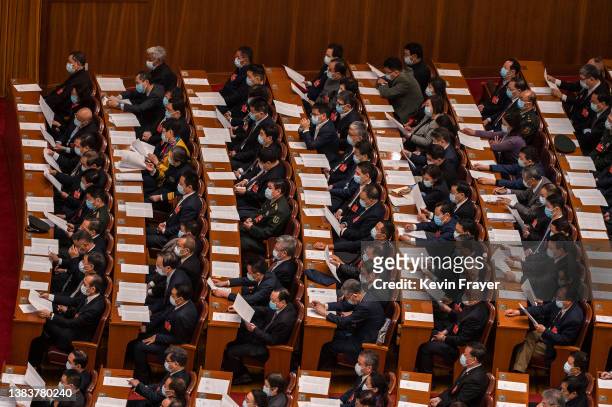 Delegates take part in the closing session of the Chinese People's Political Consultative Conference at the Great Hall of the People on March 10,...