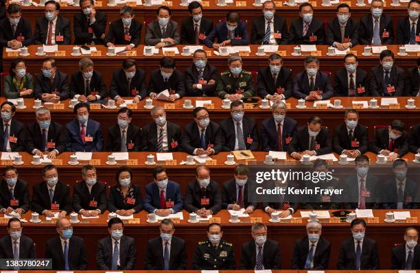 Delegates take part in the closing session of the Chinese People's Political Consultative Conference at the Great Hall of the People on March 10,...