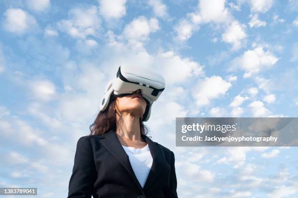 business female using virtual reality simulator headset - mixed reality ストックフォトと画像