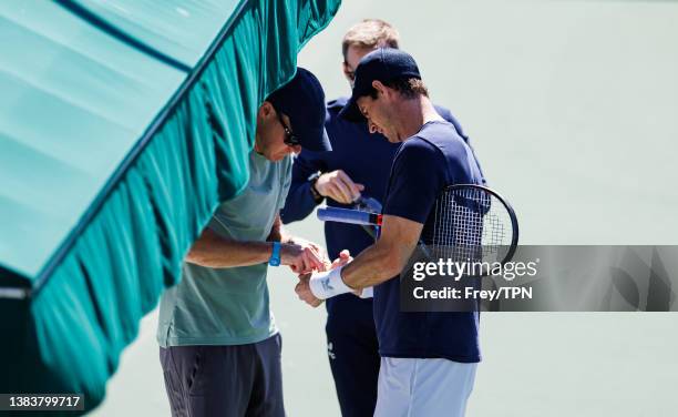 Andy Murray of Great Britain has treatment for a hand injury during a practice session before the start of the BNP Paribas Open on March 09, 2022 in...
