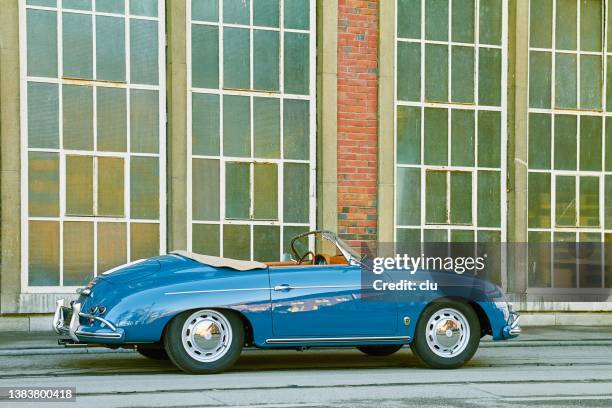 blue porsche vintage speedster parked at an inudstrial building - old car side view stock pictures, royalty-free photos & images