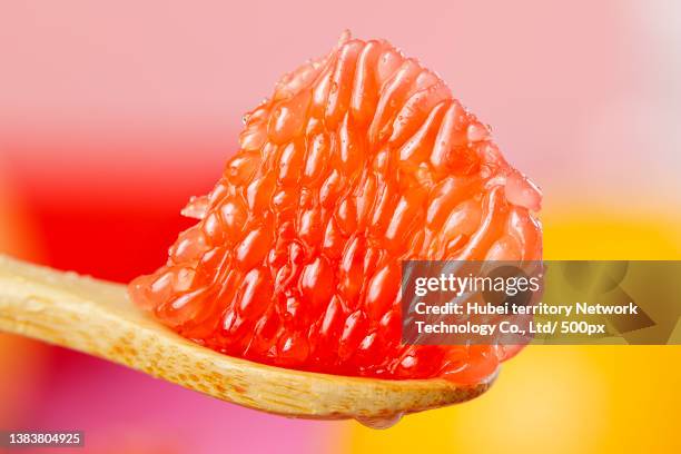 red heart grapefruit pulp in spoon - fruktkött bildbanksfoton och bilder