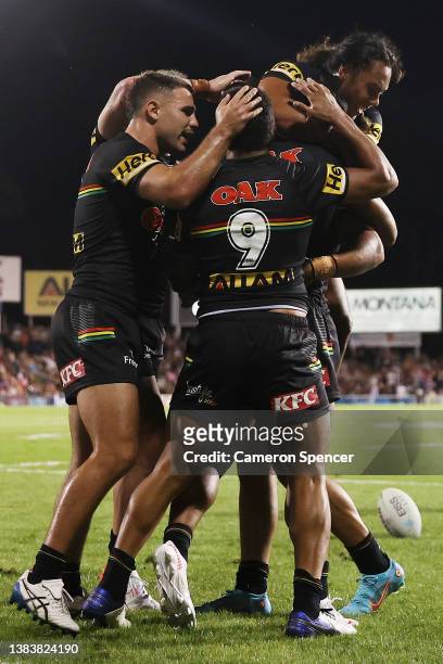 Izack Tago of the Panthers celebrates with team mates after scoring a try during the round one NRL match between the Penrith Panthers and the Manly...