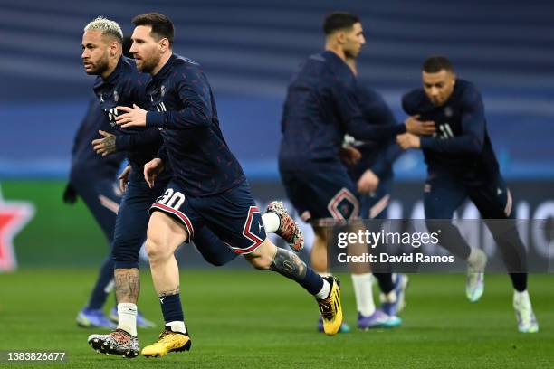 Neymar and Lionel Messi of Paris Saint-Germain warm up prior to the UEFA Champions League Round Of Sixteen Leg Two match between Real Madrid and...