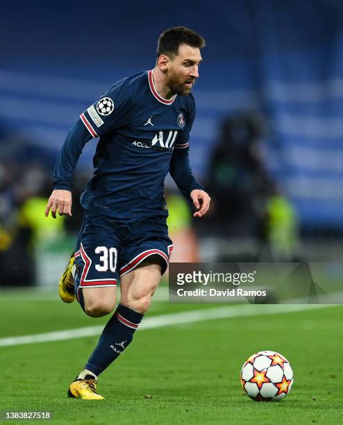 Lionel Messi of Paris Saint-Germain runs with the ball during the UEFA Champions League Round Of Sixteen Leg Two match between Real Madrid and Paris...