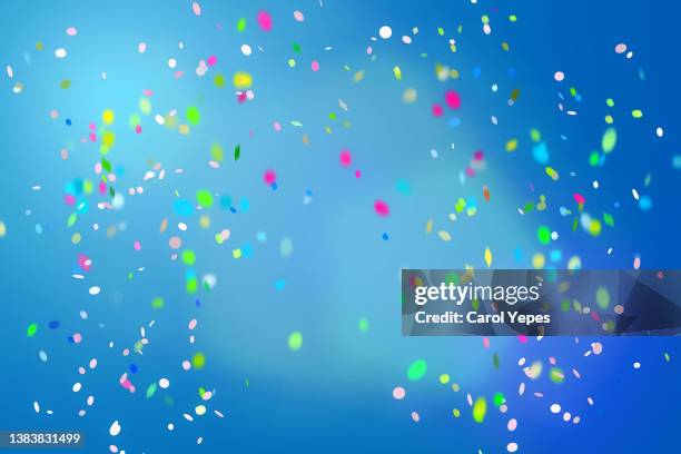 confetti in blue background - winning background stock pictures, royalty-free photos & images